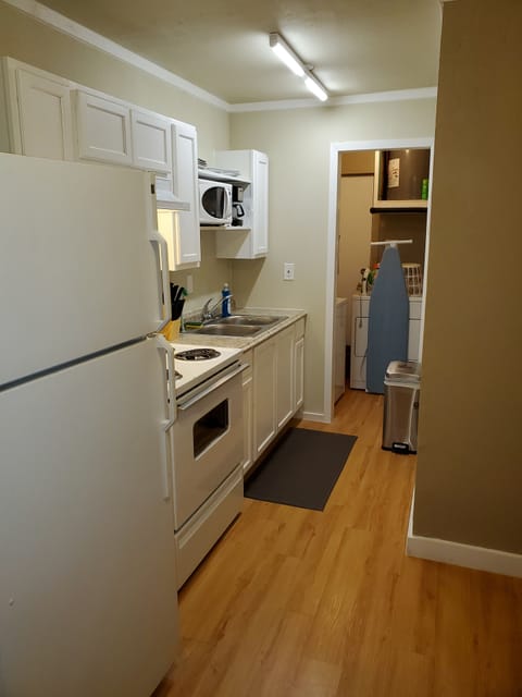 Full kitchen with adjacent utility room with full size washer and dryer