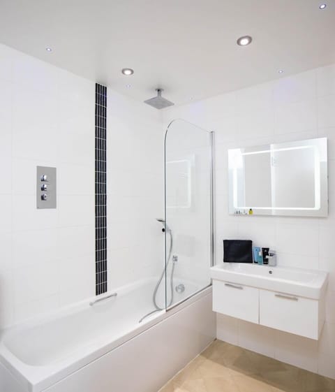 Suite, 1 King Bed with Sofa bed, Non Smoking | Bathroom | Combined shower/tub, free toiletries, hair dryer, bathrobes