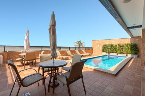 Outdoor pool, open 8:00 AM to 11:00 PM, pool umbrellas, sun loungers