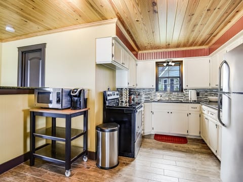 Generously equipped kitchen in the main house makes preparing meals easy.