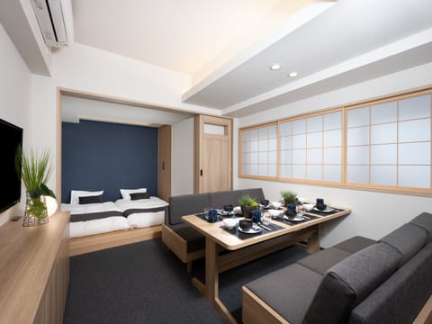 Deluxe One-Bedroom Japanese Apartment | Living area | 100-cm TV with digital channels