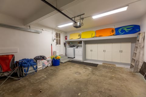 Garage with boogie boards, beach chairs, beach toys, and laundry all available