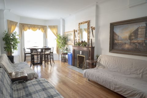 Living room has plenty of seating and decorative fireplace