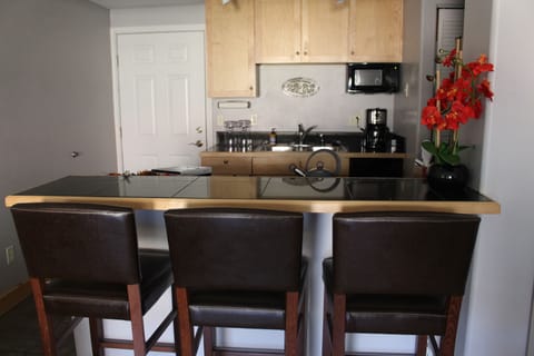 Granite tiled counter top with leather high back chairs make for perfect dining