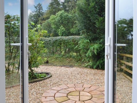 Patio doors leading to outdoor area | Blaithwaite Cottage - Blaithwaite Estate, Waverton, near Wigton