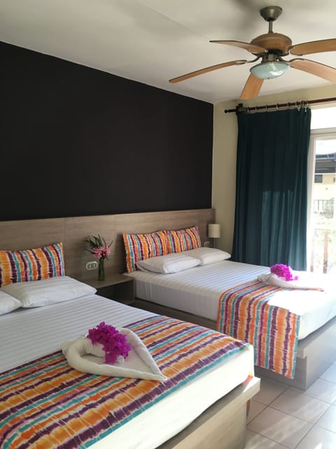 Quadruple Room, Pool View | In-room safe, desk, free WiFi, bed sheets