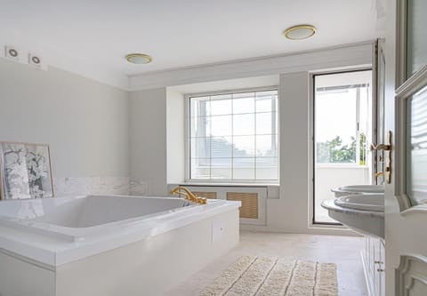 Elite Apartment | Bathroom | Hair dryer, slippers, towels, soap