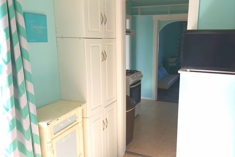 The sunny kitchen has a door leading to the large deck.