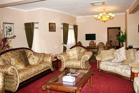 Presidential Suite, 2 Bedrooms | Living room | 24-inch flat-screen TV with cable channels, TV