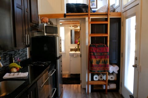 Looking into bathroom and loft (shower and toilet and sink in bathroom)