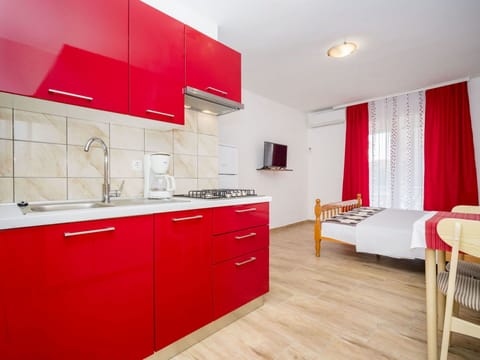 Red, Room, Interior Design, Property, Furniture, Cabinetry, Countertop, Kitchen, Floor, Building