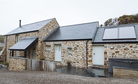The Mill House and hot tub from the drive