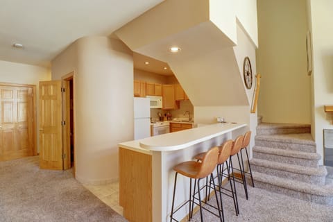 Open kitchen with barstool seating area.