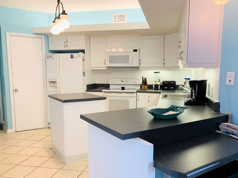 Condo, 3 Bedrooms, Balcony, Beachfront (1104A) | Private kitchen | Full-size fridge, microwave, oven, stovetop