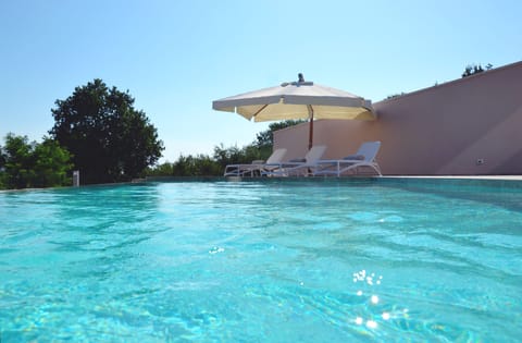 Seasonal outdoor pool, open 9:00 AM to 8:00 PM, pool umbrellas