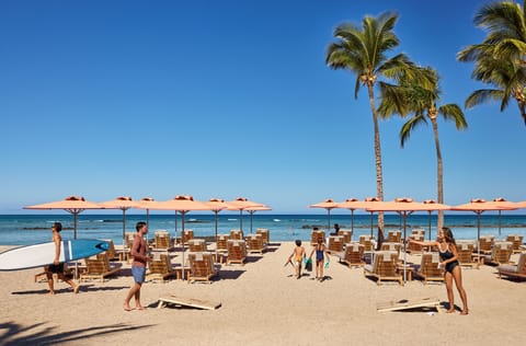 On the beach, white sand, beach cabanas, sun loungers