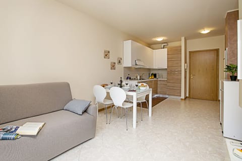 The double sofa bed with dining area and open kitchen.