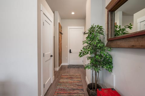 Hallway from entrance with closet and a half bath to the side.