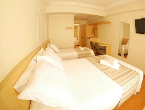 Standard Triple Room | Minibar, in-room safe, desk, blackout drapes