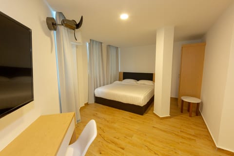King Suite Room | Desk, blackout drapes, iron/ironing board, free WiFi