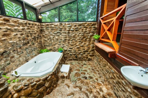 Jungle Lodge | Bathroom | Shower, rainfall showerhead, slippers, towels