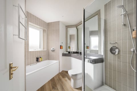 Suite, 1 King Bed, Balcony | Bathroom | Combined shower/tub, free toiletries, hair dryer, towels