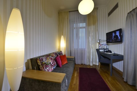 Junior Suite, 1 King Bed | Living area | 32-inch flat-screen TV with cable channels, TV