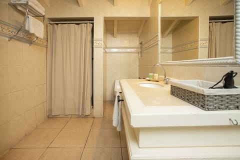 Suite, 1 King Bed | Bathroom | Combined shower/tub, jetted tub, designer toiletries, hair dryer