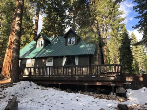 Front view with front and side decks and fenced backyard