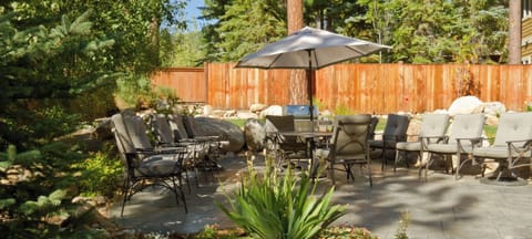 Separate outdoor BBQ and patio area with multiple chairs and spacious seating