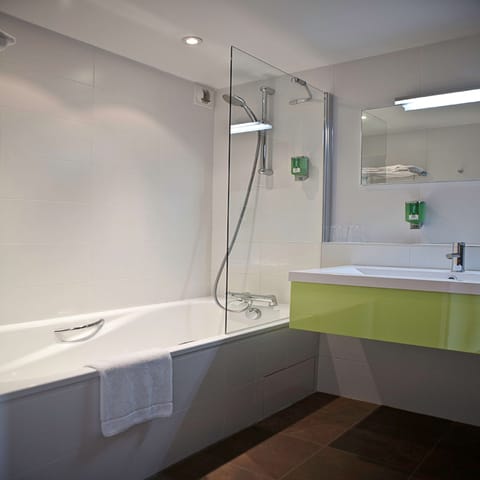 Bathtub, hair dryer, bathrobes, towels