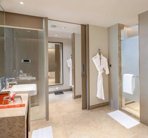 Suite, 1 King Bed (Junior Suite) | Bathroom | Rainfall showerhead, designer toiletries, hair dryer, bathrobes