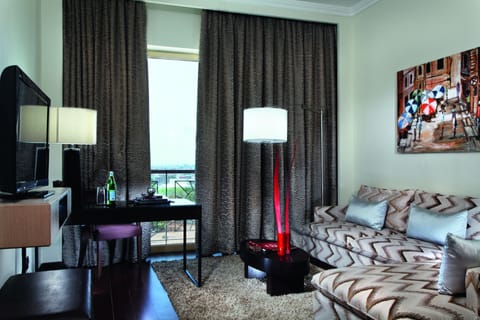 Executive Suite, Pool View | Living room | 46-inch LCD TV with premium channels, TV