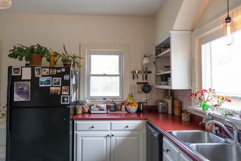Kitchen with full size fridge, plenty of countertops, and large windows