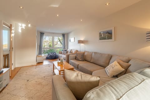 Sea Folly, Perranporth. First floor: Sitting room with a television, double sofa bed and views across the village and out to sea