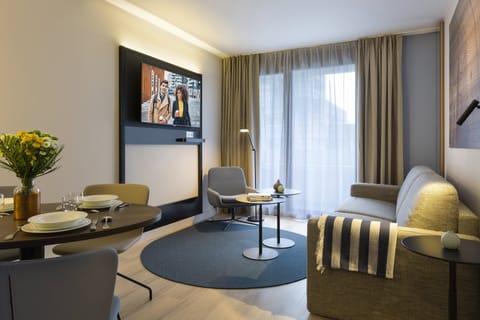 Deluxe Apartment, 1 Bedroom, Balcony | Living room | Flat-screen TV