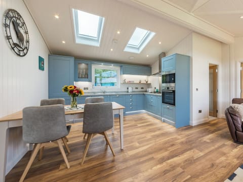 Fully equipped kitchen with dining area within the open-plan design | Karelia Lodge, Keltyneyburn, near Aberfeldy