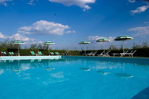 Seasonal outdoor pool, open 8:00 AM to 8:00 PM, pool umbrellas