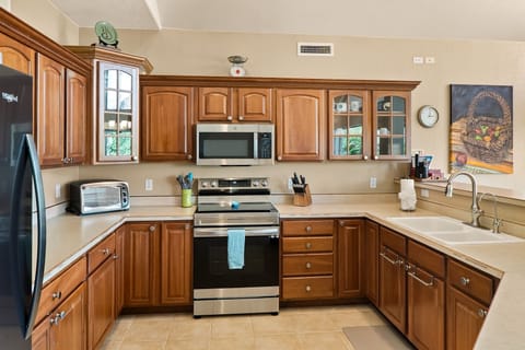 The kitchen is spacious and very well-equipped with modern appliances and amenities
