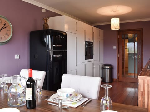 Elegant dining area overlooking the large garden | Cushendall House, Banavie, near Fort William