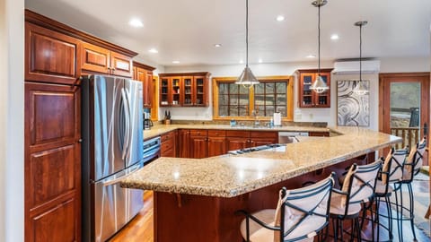 Fully stocked open concept kitchen with breakfast bar seating for 4, two ovens, gas stove, brand new appliances, drip pot coffee maker, and pantry.