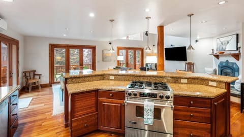 Fully stocked open concept kitchen with breakfast bar seating for 4, two ovens, gas stove, brand new appliances, drip pot coffee maker, and pantry.