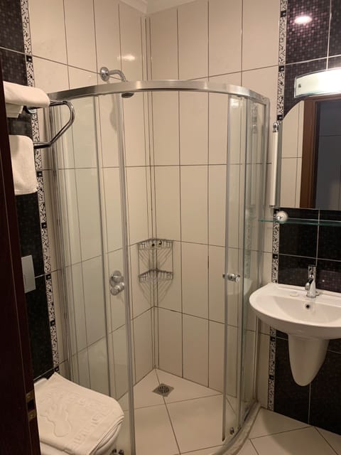 Economy Double Room | Bathroom | Shower, hair dryer, slippers, towels