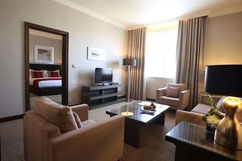 Premium Suite, 1 King Bed | Living room | Flat-screen TV