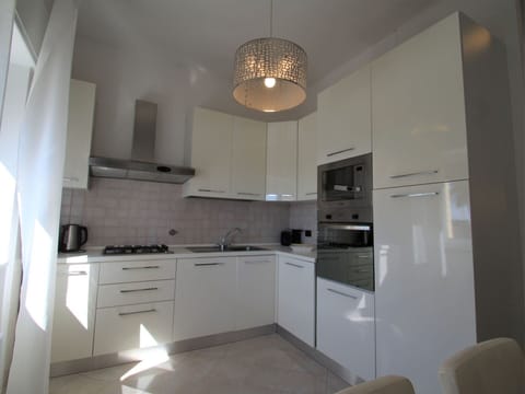 Cabinetry, Countertop, Property, Kitchen, Wood, Kitchen Stove, Interior Design, Flooring, Kitchen Appliance, Floor