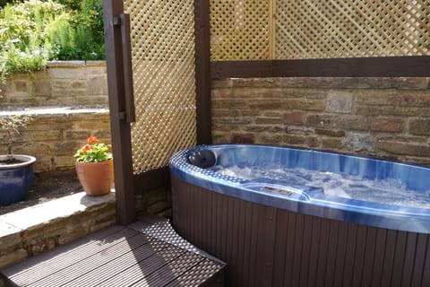 Hot tub just for two - covered so you can take a soak whatever the weather.