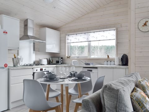 Fully equipped kitchen with dining area within the open-plan design | The Den - Invernahavon, Glentruim, near Newtonmore