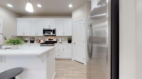 Fully stocked gourmet kitchen featuring stainless steel appliances