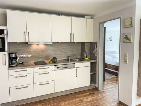 Kitchen, Countertop, Cabinetry, Kitchen Appliance, Furniture, Flooring, Wood, Interior Design, Major Appliance, Floor