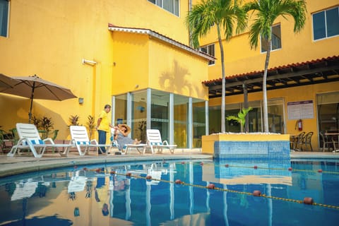 Outdoor pool, open 9:00 AM to 9:00 PM, pool umbrellas, sun loungers